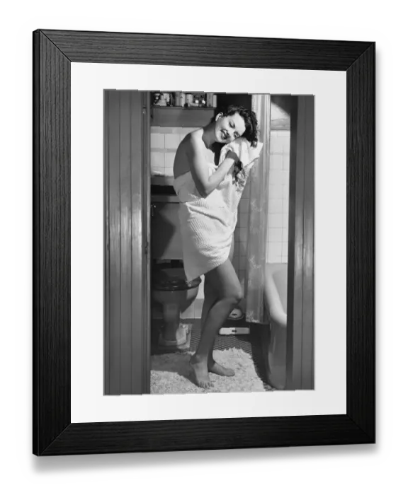 Framed Print : Woman standing in bathroom, wrapped in towel Framed Print : Woman standing in bathroom, wrapped in towel