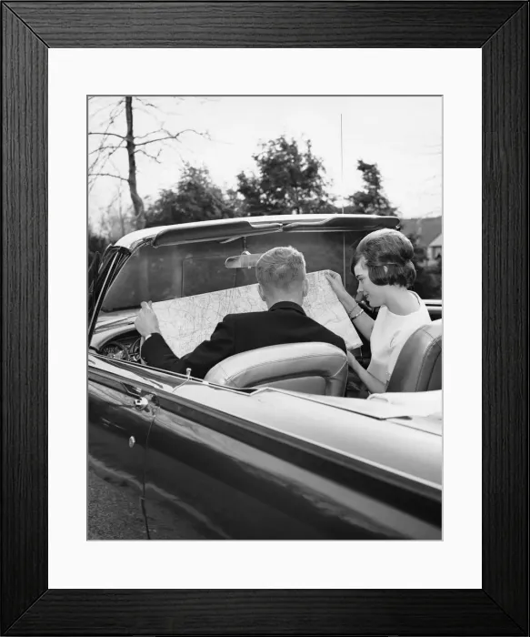 Framed Print : Couple in convertible looking at roadmap Framed Print : Couple in convertible looking at roadmap