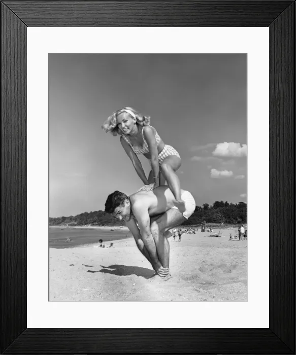 Framed Print : Couple playing leapfrog on beach Framed Print : Couple playing leapfrog on beach