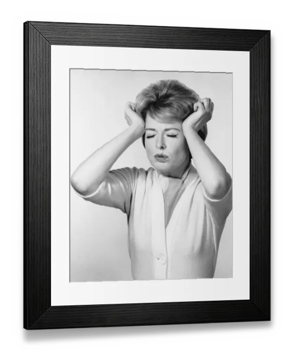 Framed Print : Woman pressing hands against head Framed Print : Woman pressing hands against head
