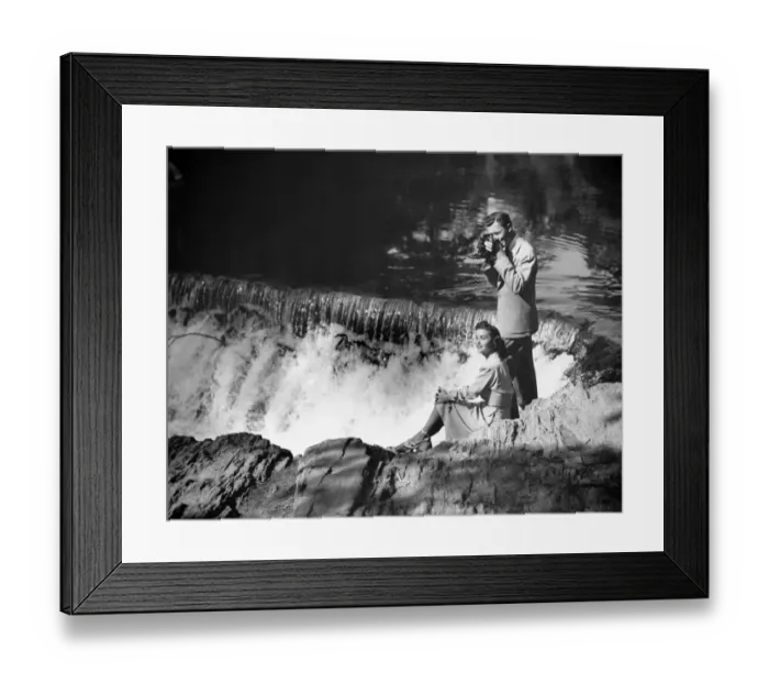 Framed Print : Young couple by waterfall, man taking picture, (B&W) Framed Print : Young couple by waterfall, man taking picture, (B&W)