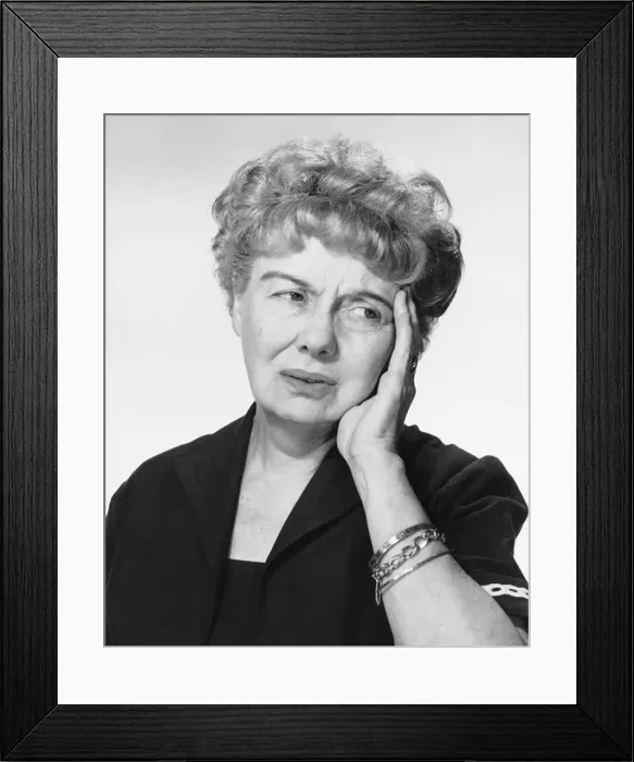 Framed Print : Woman holding hand to head Framed Print : Woman holding hand to head