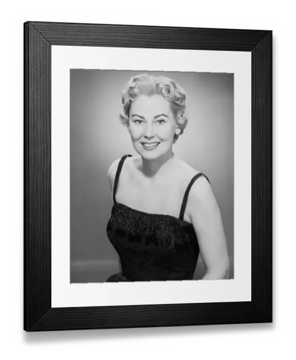 Framed Print : Studio portrait of mid adult woman smiling Framed Print : Studio portrait of mid adult woman smiling