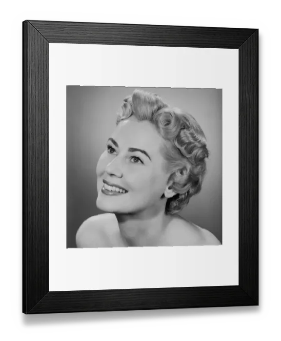 Framed Print : Studio shot of mid adult woman looking up Framed Print : Studio shot of mid adult woman looking up