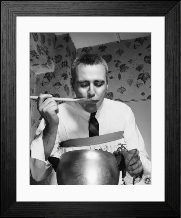 Framed Print : Male cook tasting food Framed Print : Male cook tasting food