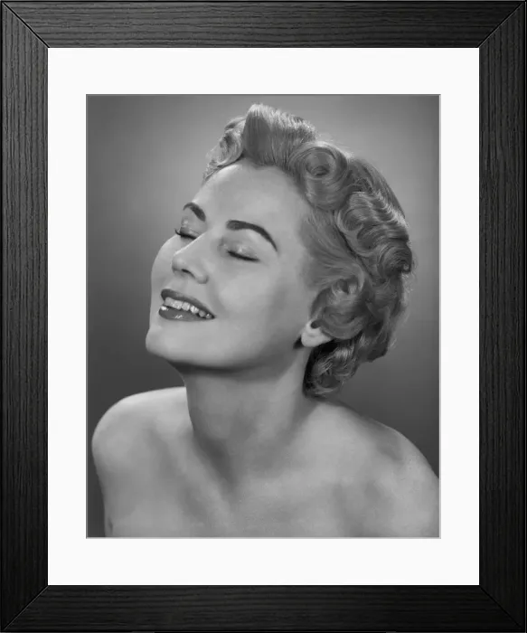 Framed Print : Studio shot of mid adult woman with eyes closed Framed Print : Studio shot of mid adult woman with eyes closed