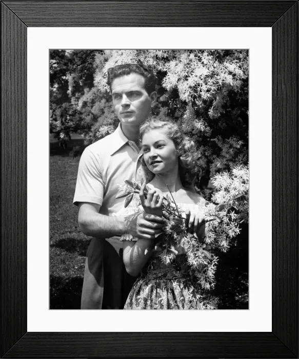 Framed Print : Young couple posing at blooming tree in park, (B&W), (Portrait) Framed Print : Young couple posing at blooming tree in park, (B&W), (Portrait)