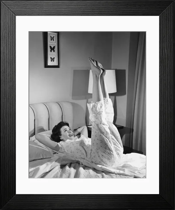 Framed Print : Woman stretching on bed Framed Print : Woman stretching on bed