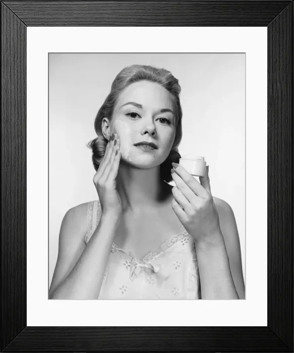 Framed Print : Woman putting cream on face Framed Print : Woman putting cream on face