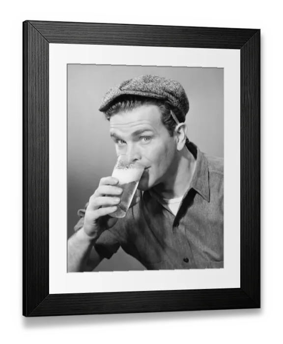 Framed Print : Workman in cap drinking beer in studio, (B&W), (Close-up), (Portrait) Framed Print : Workman in cap drinking beer in studio, (B&W), (Close-up), (Portrait)