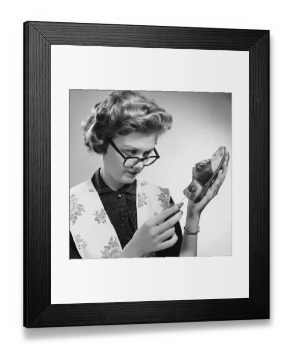 Framed Print : Woman cleaning scuffed shoe Framed Print : Woman cleaning scuffed shoe