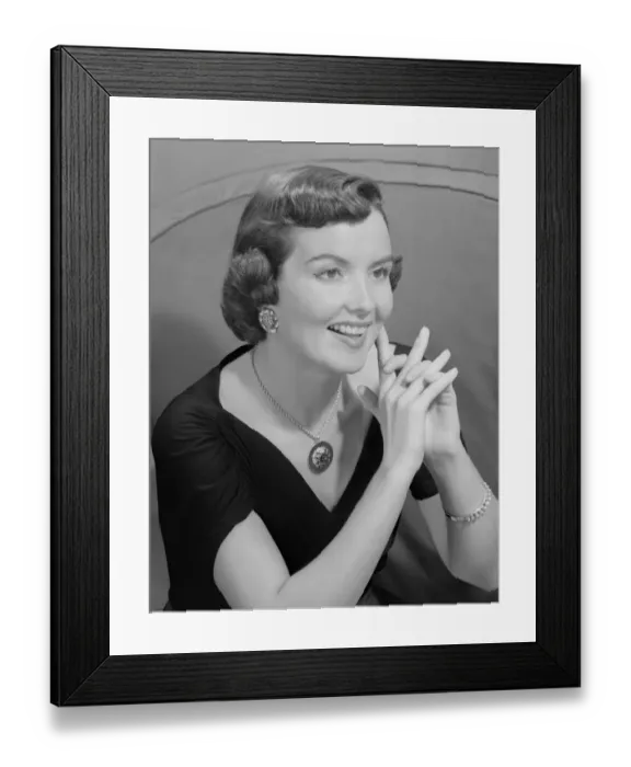 Framed Print : Young woman with hand clasped, indoors Framed Print : Young woman with hand clasped, indoors