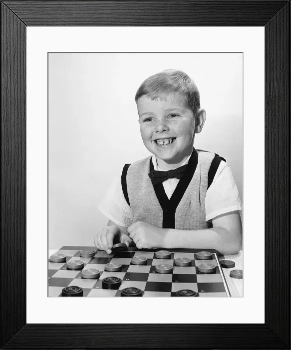 Framed Print : Boy playing checkers Framed Print : Boy playing checkers