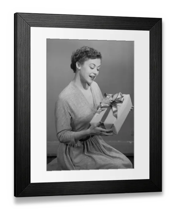 Framed Print : Mature woman holding gift box