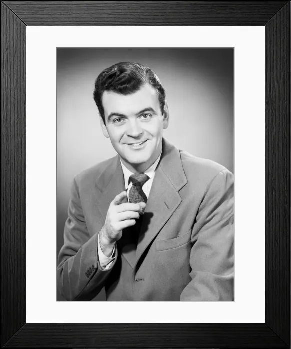 Framed Print : Studio portrait of mid adult man pointing Framed Print : Studio portrait of mid adult man pointing