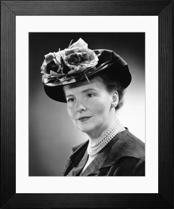 Framed Print : Mature woman in flowered hat posing in studio, (B&W), (Close-up), (Portrait) Framed Print : Mature woman in flowered hat posing in studio, (B&W), (Close-up), (Portrait)
