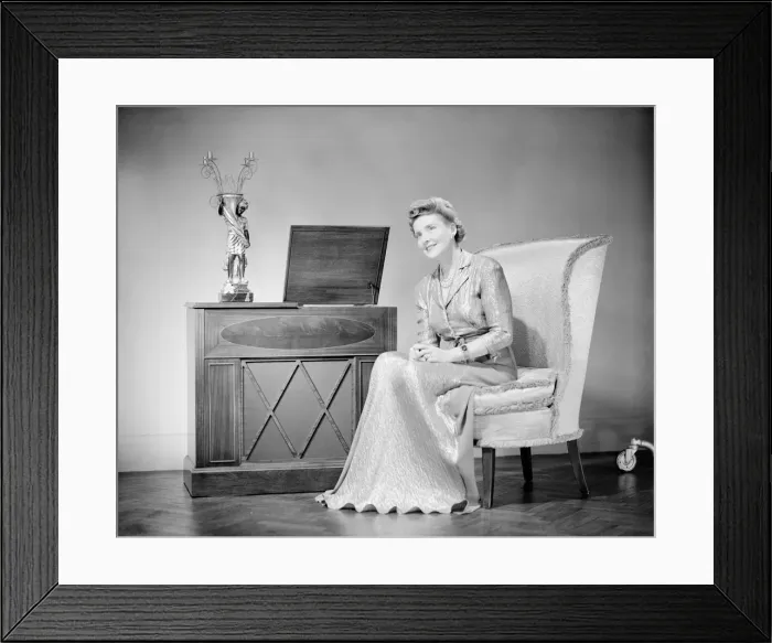 Framed Print : Mature woman sitting on chair, portrait Framed Print : Mature woman sitting on chair, portrait