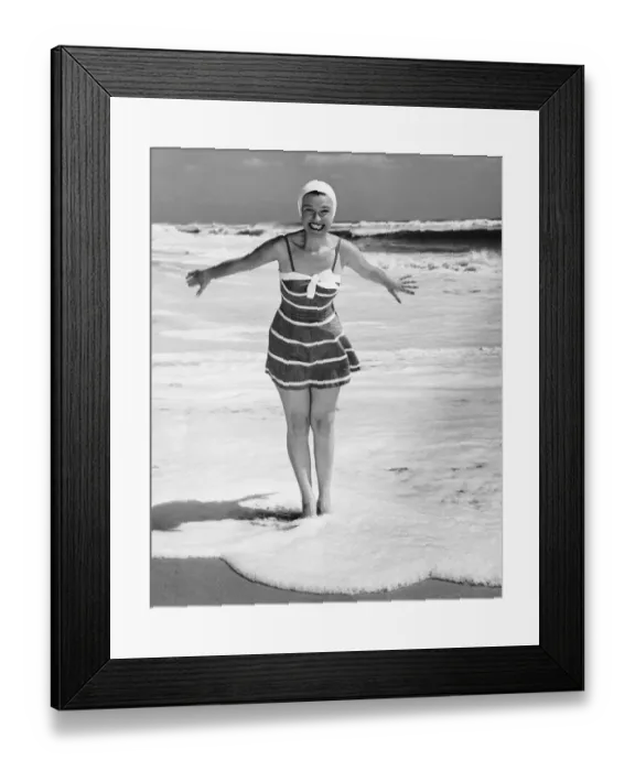 Framed Print : Woman standing in shallow water at ocean Framed Print : Woman standing in shallow water at ocean