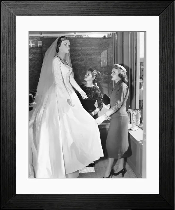 Framed Print : Two women looking at wedding dress on mannequin Framed Print : Two women looking at wedding dress on mannequin