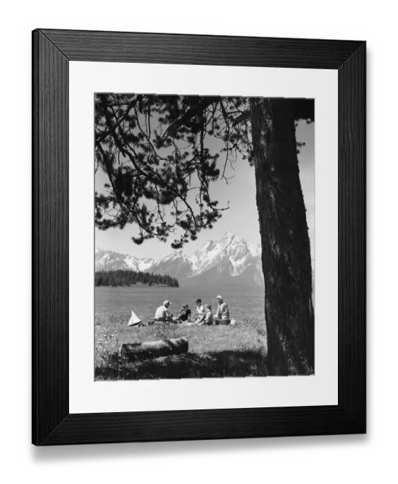 Framed Print : Family having picnic by lake; mountains in background Framed Print : Family having picnic by lake; mountains in background