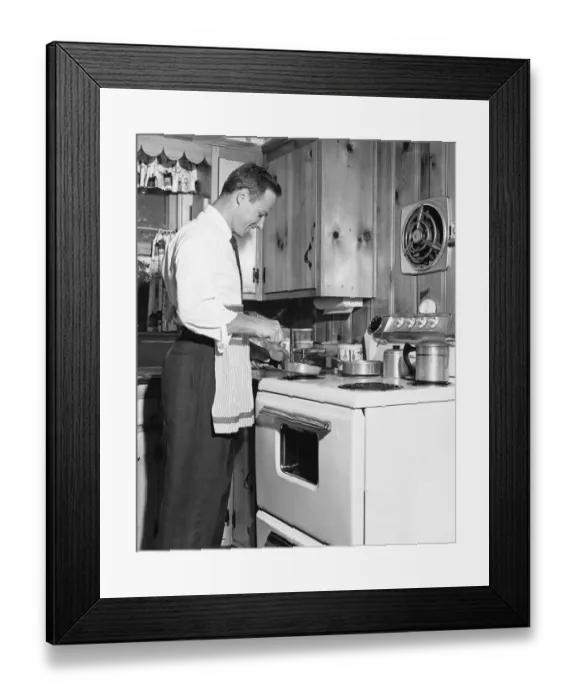 Framed Print : Man cooking at stove Framed Print : Man cooking at stove