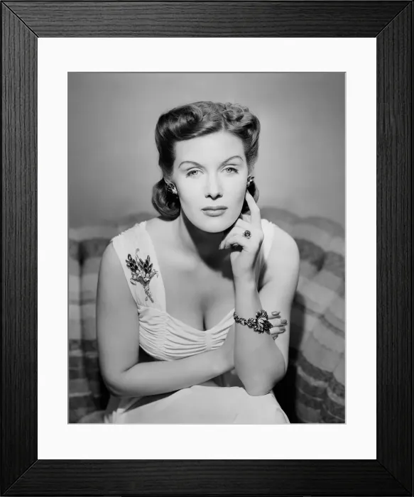 Framed Print : Portrait of mid adult woman sitting on sofa Framed Print : Portrait of mid adult woman sitting on sofa