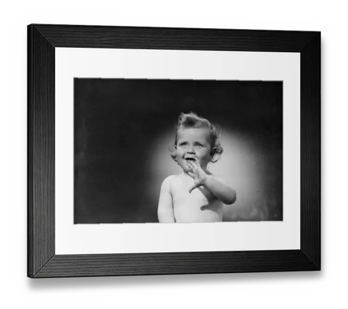 Framed Print : Studio shot of baby (6-11 months) waving hand Framed Print : Studio shot of baby (6-11 months) waving hand