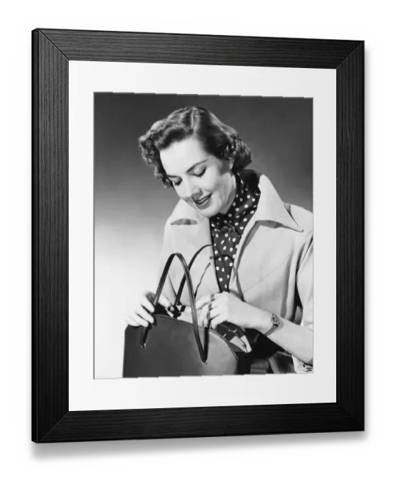 Framed Print : Woman looking into purse Framed Print : Woman looking into purse