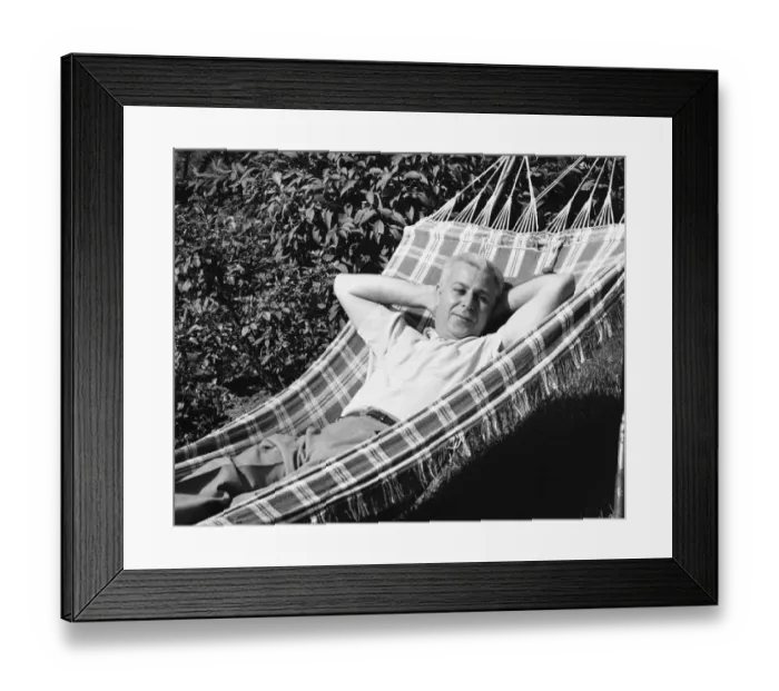 Framed Print : Man lying in hammock