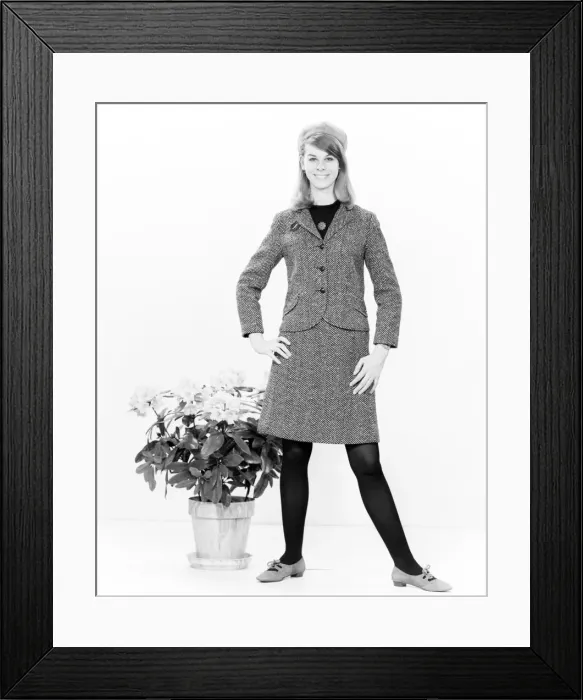 Framed Print : Portrait of young woman standing next to potted plant Framed Print : Portrait of young woman standing next to potted plant