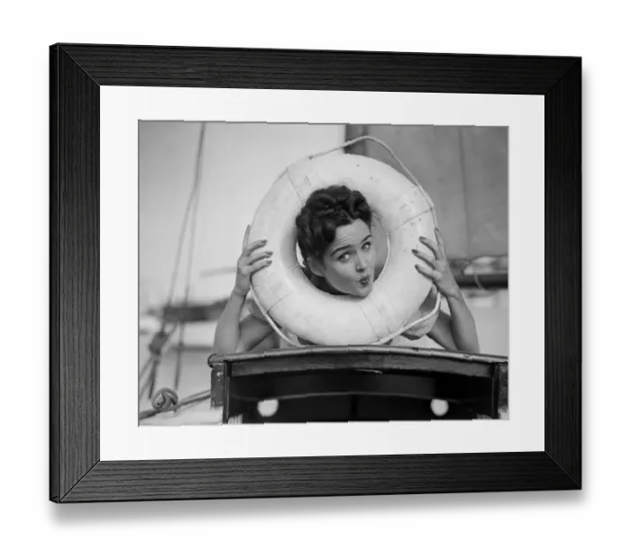 Framed Print : Young woman posing with head in life belt