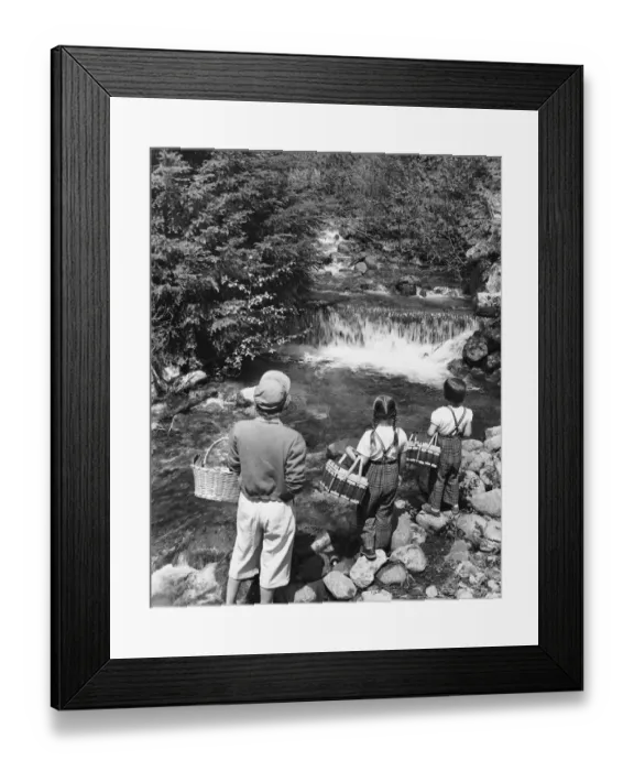 Framed Print : Mother and daughters, carrying picnic baskets, looking at waterfall Framed Print : Mother and daughters, carrying picnic baskets, looking at waterfall
