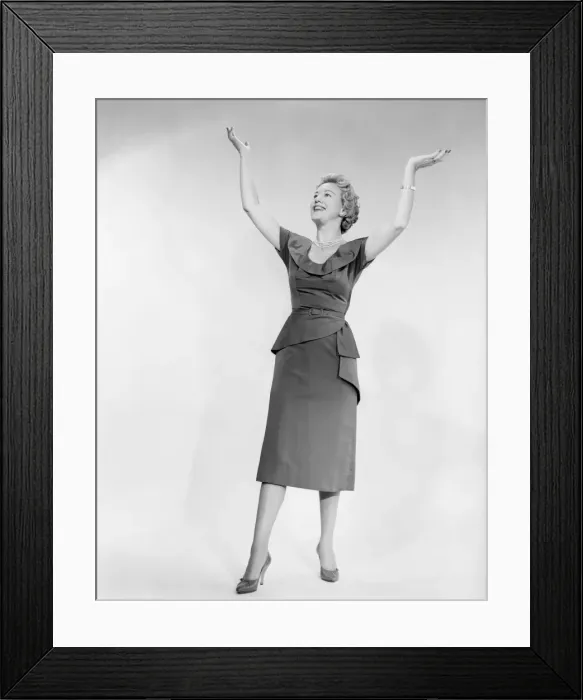 Framed Print : Woman raising arms, studio shot Framed Print : Woman raising arms, studio shot