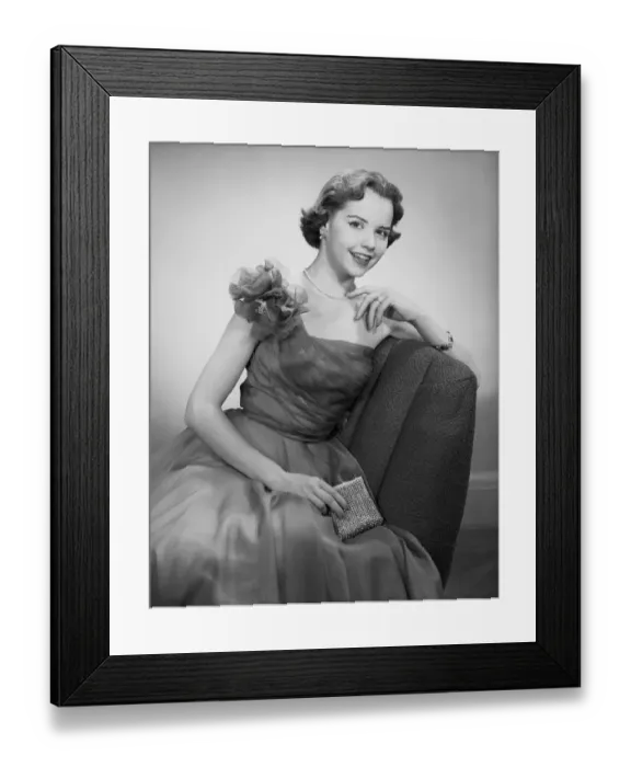 Framed Print : Woman wearing dress sitting in chair, portrait Framed Print : Woman wearing dress sitting in chair, portrait