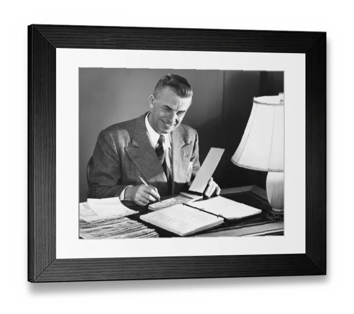 Framed Print : Man signing checks Framed Print : Man signing checks
