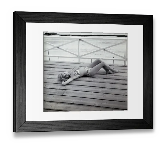 Framed Print : Portrait of young woman in bikini lying on deck Framed Print : Portrait of young woman in bikini lying on deck