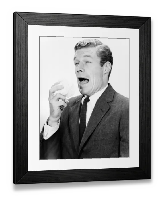 Framed Print : Studio shot of man sneezing Framed Print : Studio shot of man sneezing