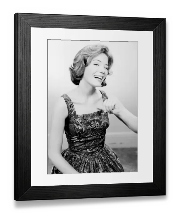 Framed Print : Studio portrait of young woman smiling Framed Print : Studio portrait of young woman smiling