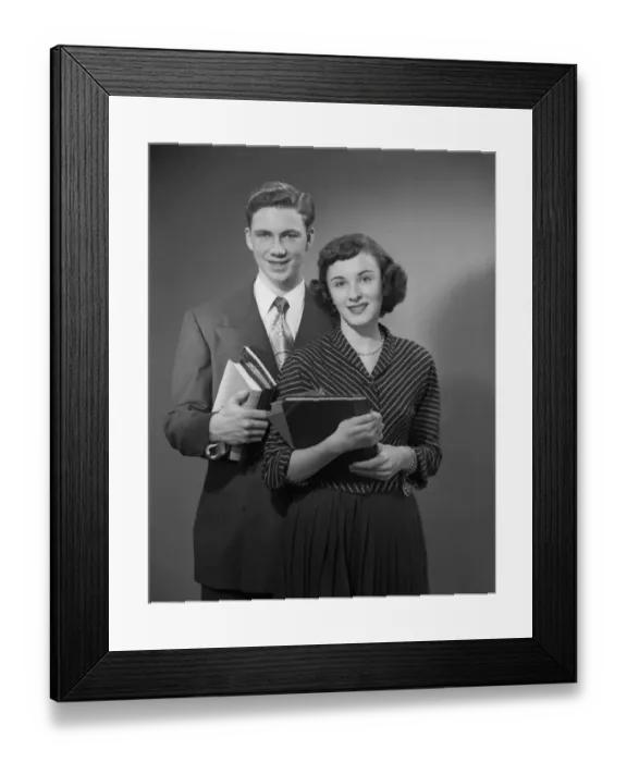 Framed Print : Young man and woman holding books, portrait Framed Print : Young man and woman holding books, portrait