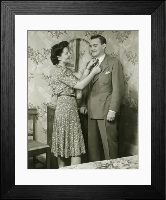 Framed Print : Woman adjusting mans tie at dressing table Framed Print : Woman adjusting mans tie at dressing table