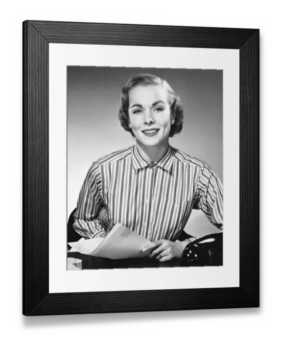 Framed Print : Woman holding paper, posing and smiling Framed Print : Woman holding paper, posing and smiling