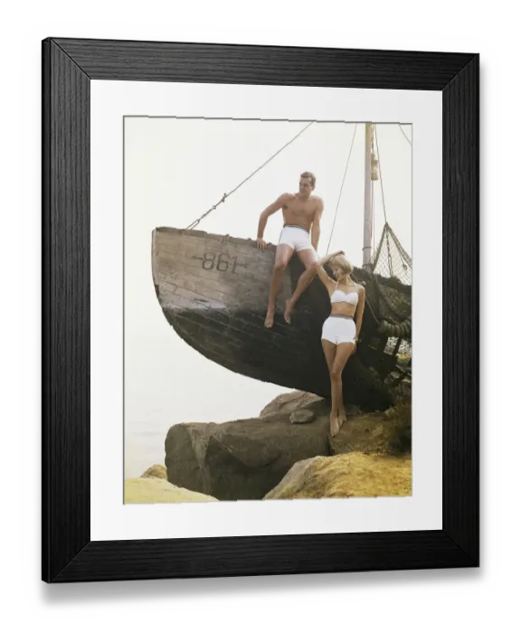 Framed Print : Man sitting boat, woman standing beside