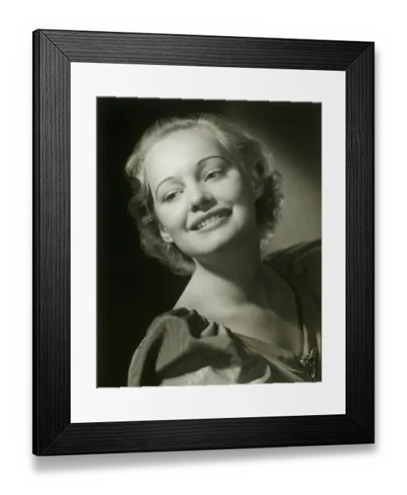 Framed Print : Young woman smiling, close-up, studio shot