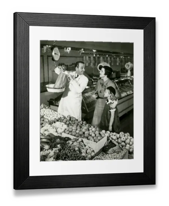 Framed Print : Mother and daughter in supermarket, shop assistant weighing groceries