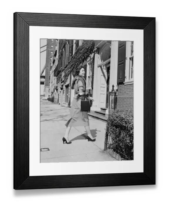 Framed Print : Elegant woman walking outside apartment buildings