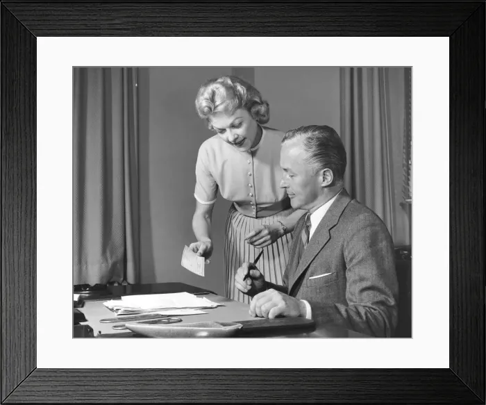 Framed Print : Woman showing man cheque, man holding pen Framed Print : Woman showing man cheque, man holding pen
