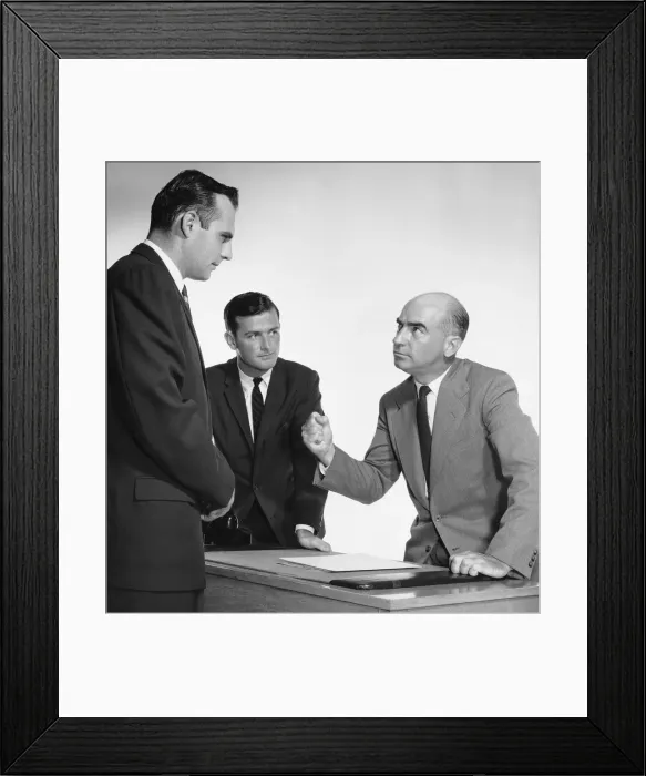 Framed Print : Man threatening two workers