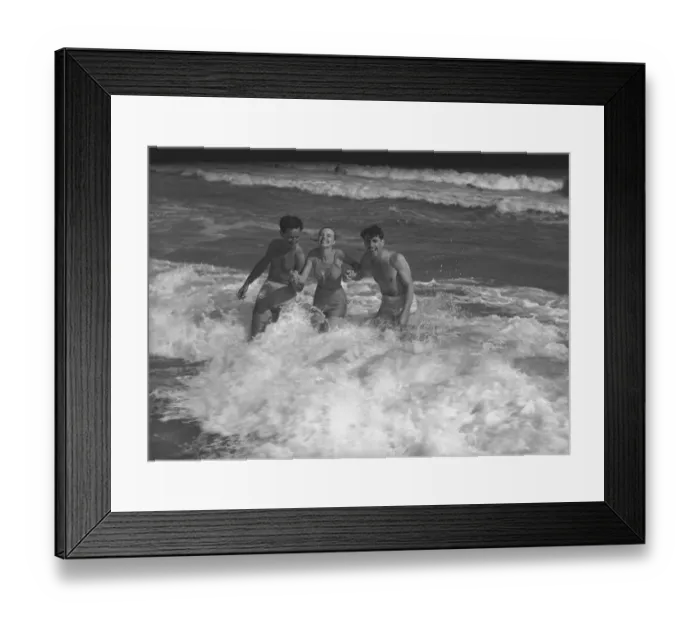 Framed Print : Two young man and woman playing in wave, (B&W) Framed Print : Two young man and woman playing in wave, (B&W)