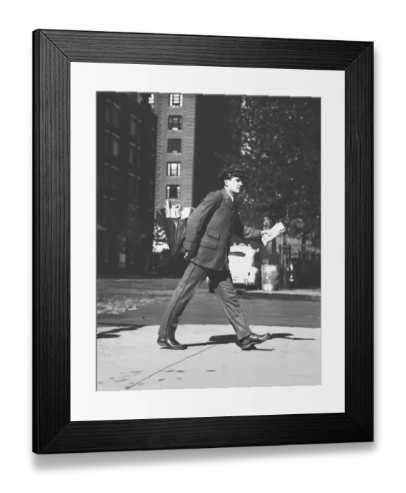 Framed Print : Mailman holding letters walking on street, (B&W)