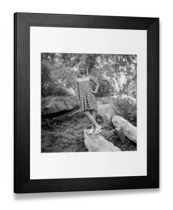 Framed Print : Girl (12-13) standing on boulder in forest, (B&W) Framed Print : Girl (12-13) standing on boulder in forest, (B&W)